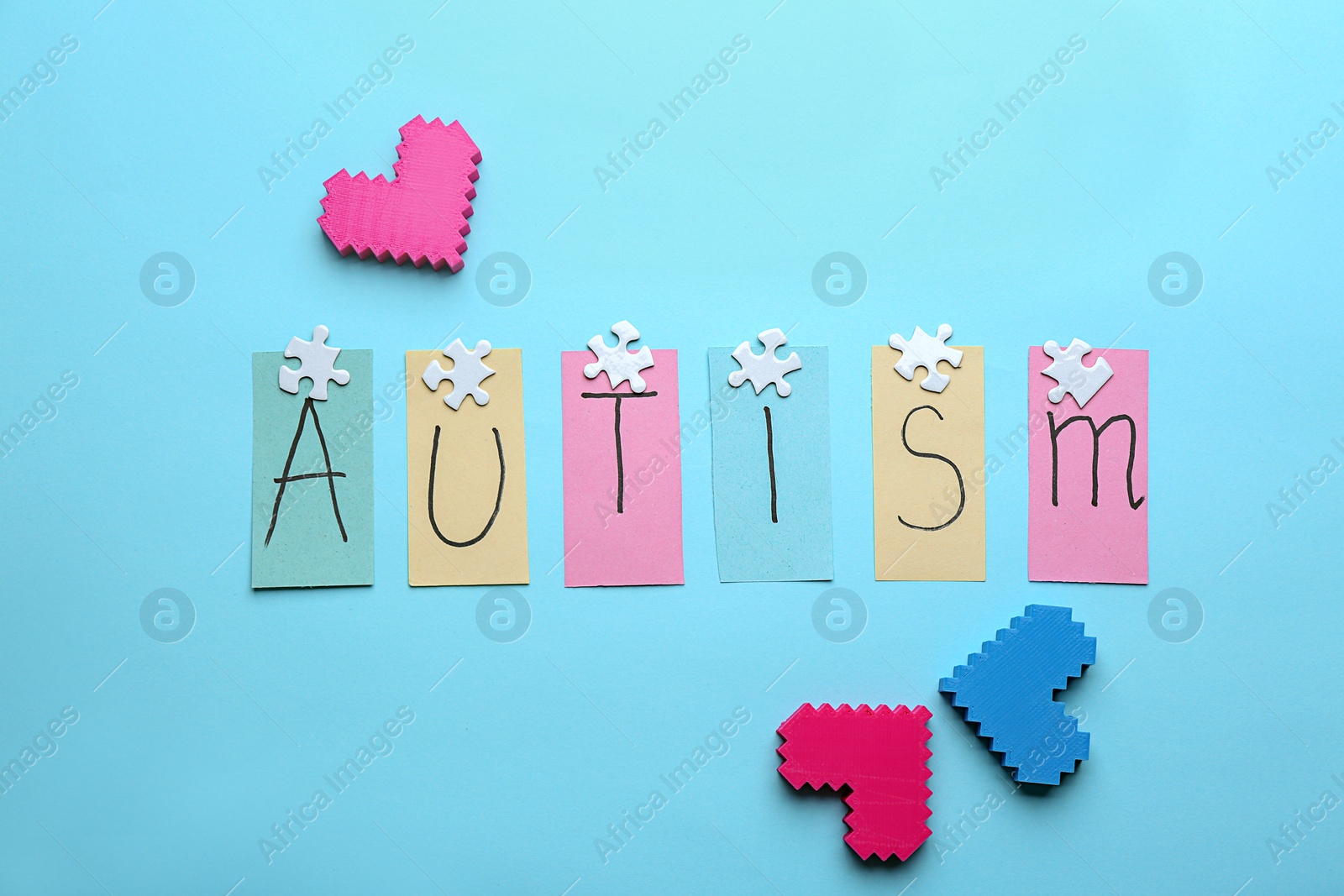 Photo of Notes with word "Autism" on color background