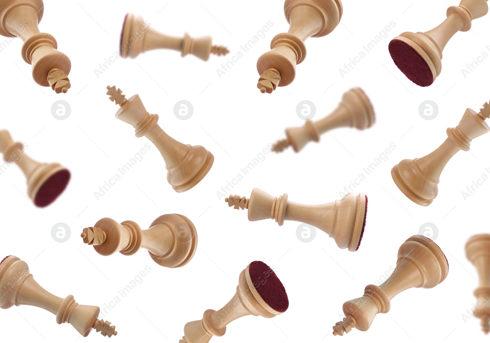 Image of Wooden chess kings falling on white background