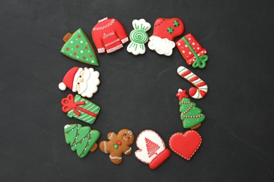 Photo of Frame of delicious Christmas cookies on black table, flat lay. Space for text