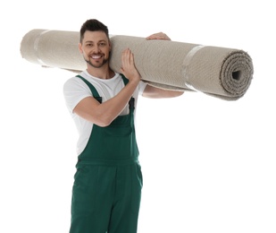 Photo of Male worker with rolled carpet on white background