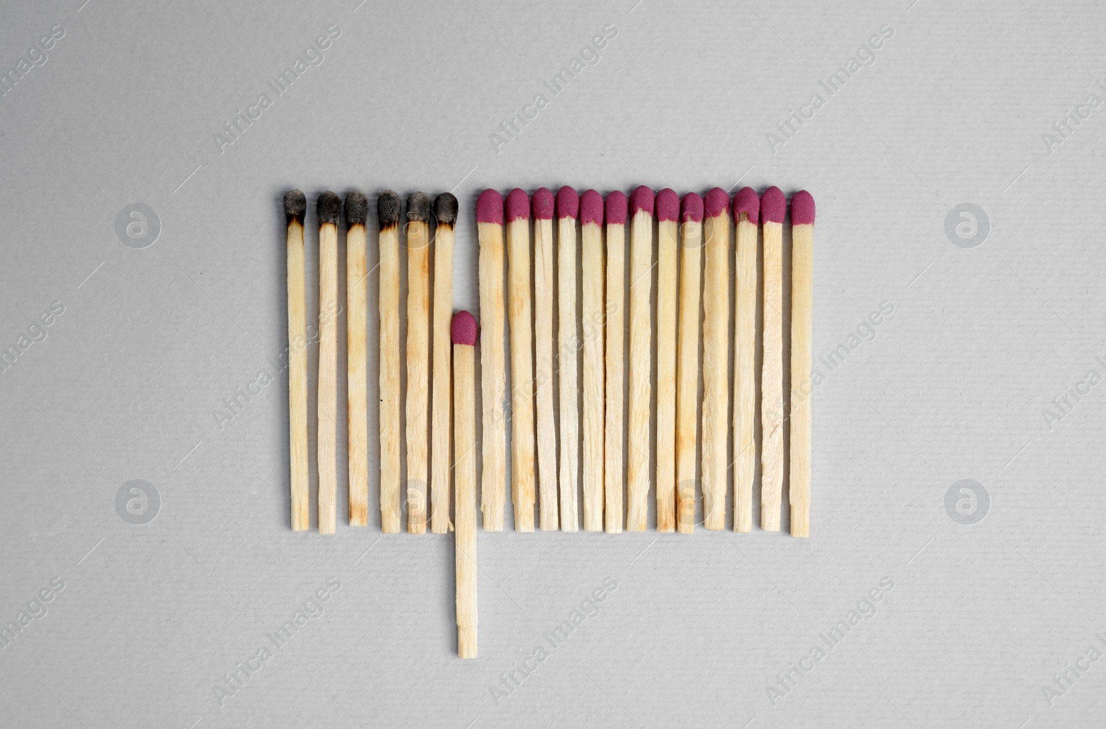 Photo of Flat lay composition with burnt and whole matches on light background