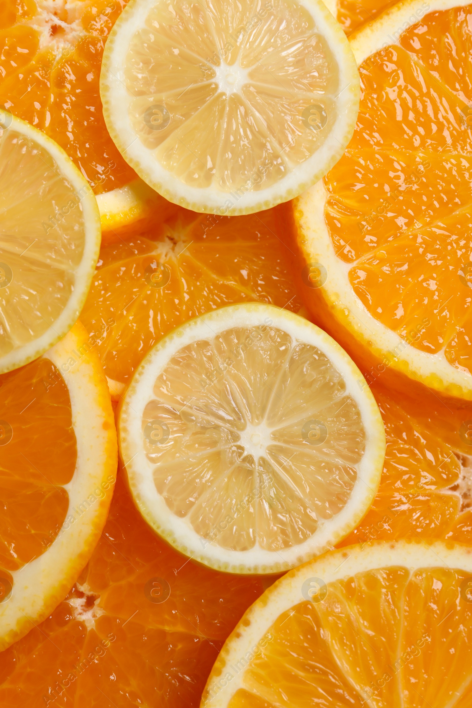 Photo of Slices of lemon and orange as background, top view