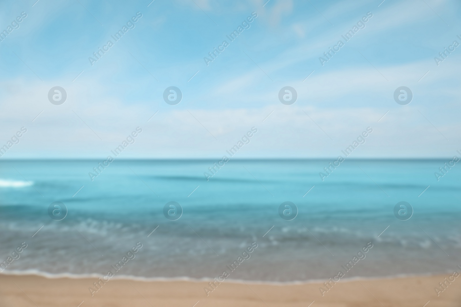 Photo of Blurred view of sea shore under blue sky on sunny day