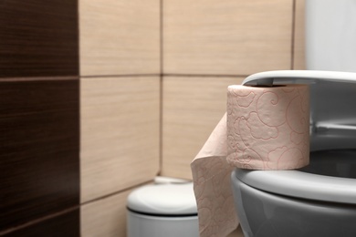 Soft tissue paper on toilet seat in bathroom. Space for text