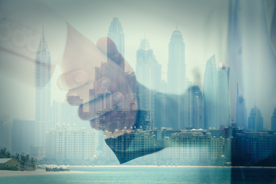 Image of Double exposure of partners shaking hands and city. Business values