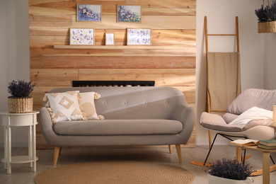 Photo of Stylish sofa and rocking chair in beautiful living room interior