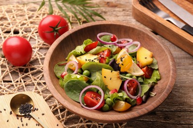 Photo of Delicious salad with peach, green peas and vegetables served on wooden table