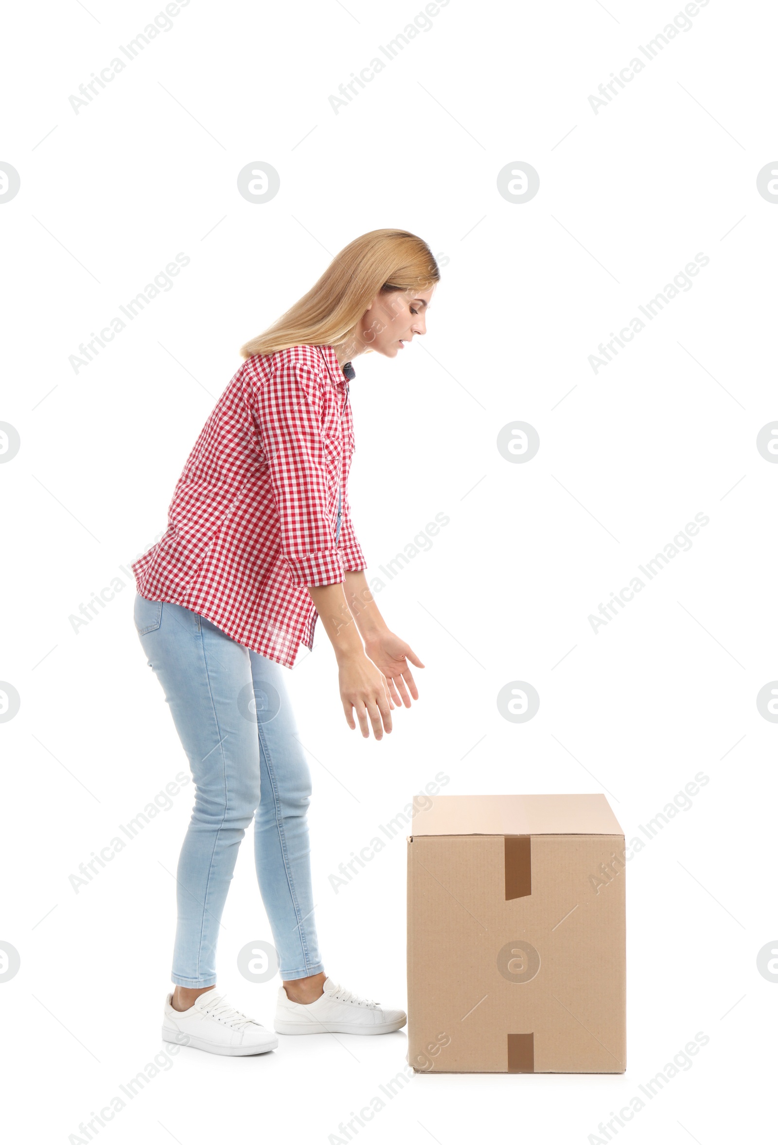 Photo of Full length portrait of woman lifting carton box on white background. Posture concept