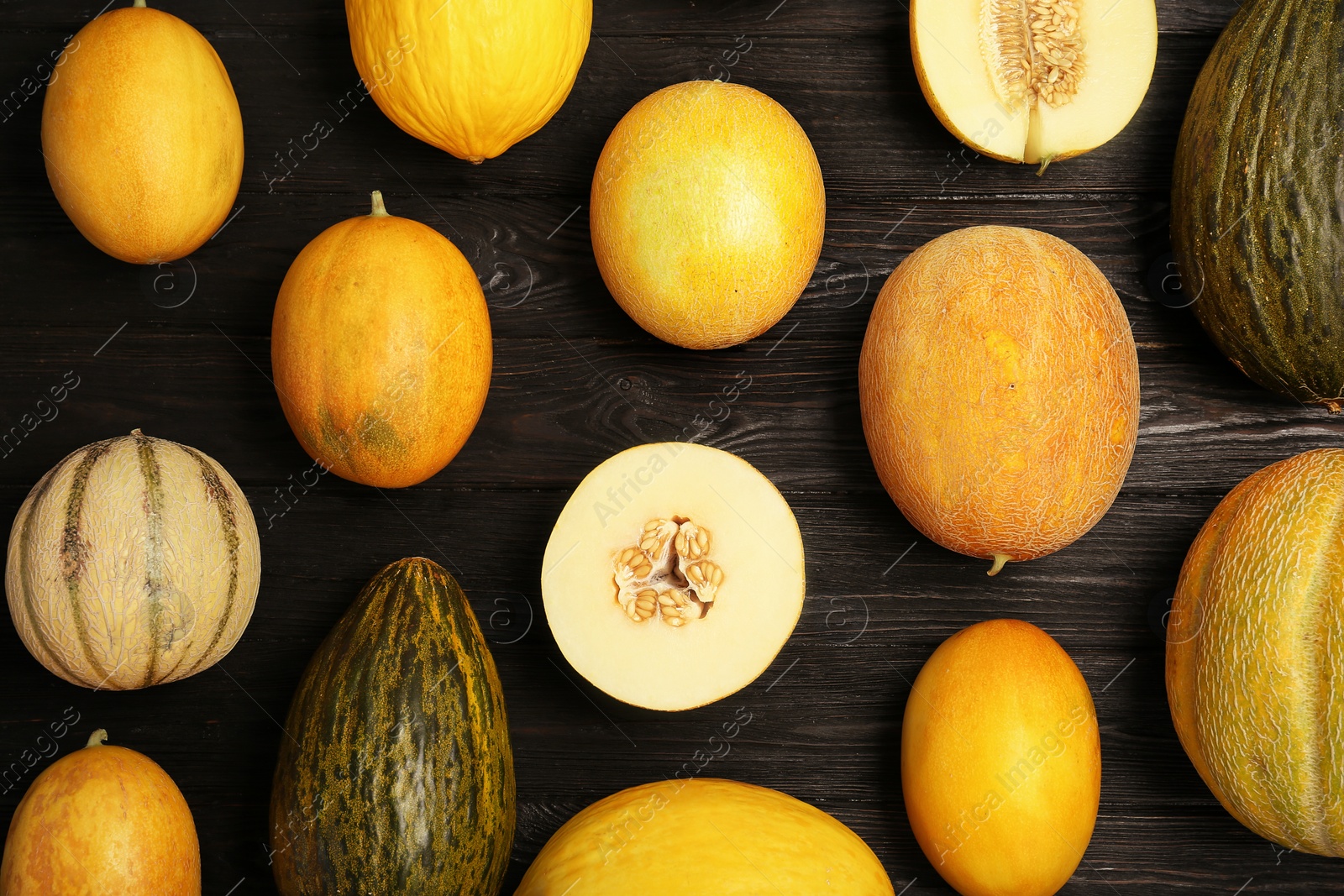 Photo of Flat lay composition with fresh tasty melons on table