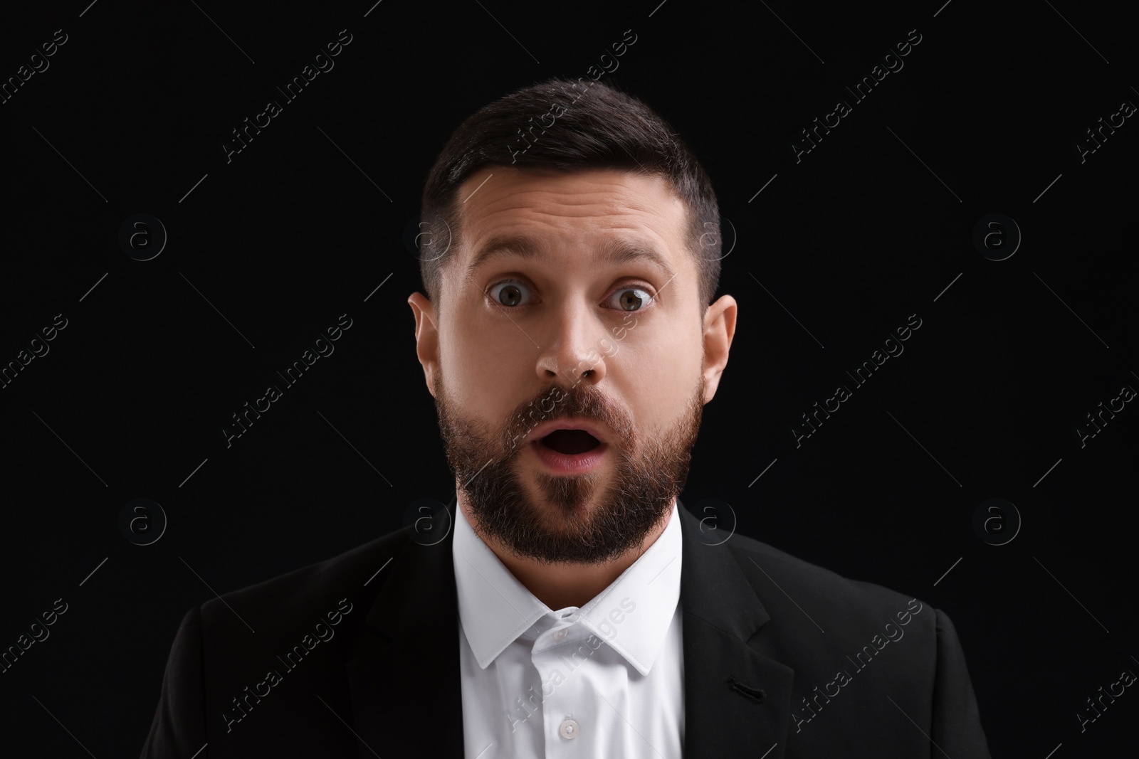 Photo of Personality concept. Portrait of surprised man on black background