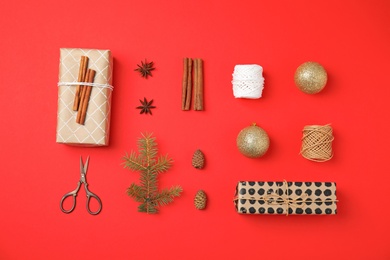 Photo of Flat lay Christmas composition with gift boxes and festive decor on color background