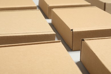 Many cardboard boxes on white background, closeup. Packaging goods