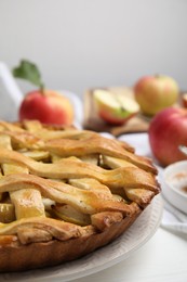 Photo of Delicious traditional apple pie on white table, closeup