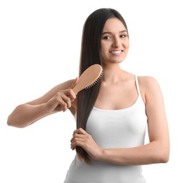 Photo of Beautiful young woman with hair brush on white background