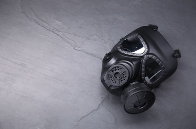 One gas mask on grey textured background, top view. Space for text