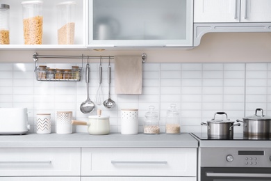 Photo of Modern kitchen interior with houseware and new furniture