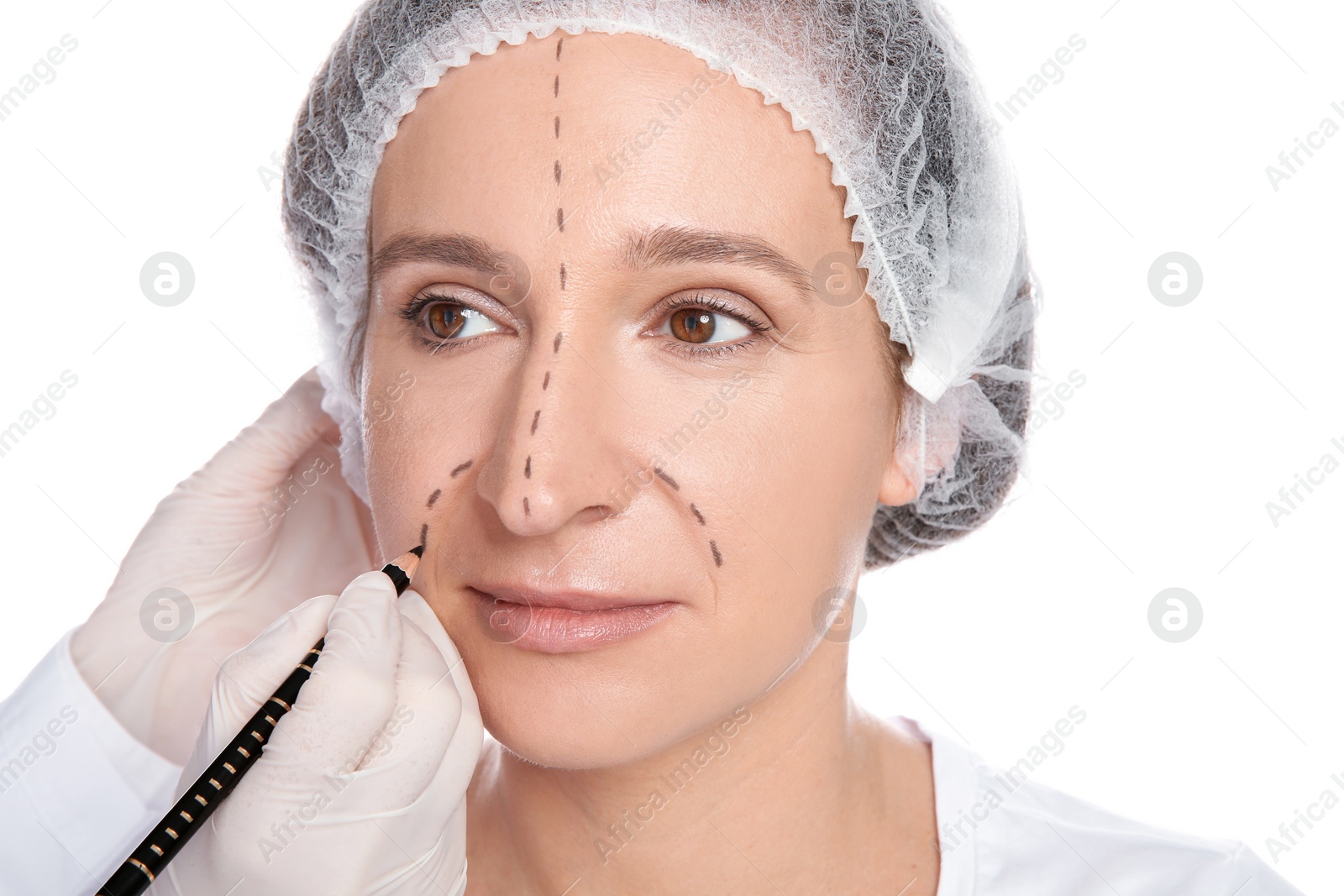 Photo of Doctor marking mature woman face before cosmetic surgery on white background