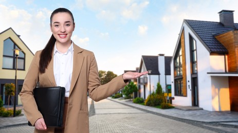 Smiling real estate agent with portfolio outdoors, space for text. Beautiful houses on street