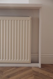 Photo of Modern panel radiator on white wall indoors