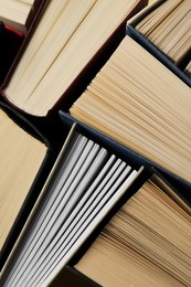 Photo of Many hardcover books as background, closeup view
