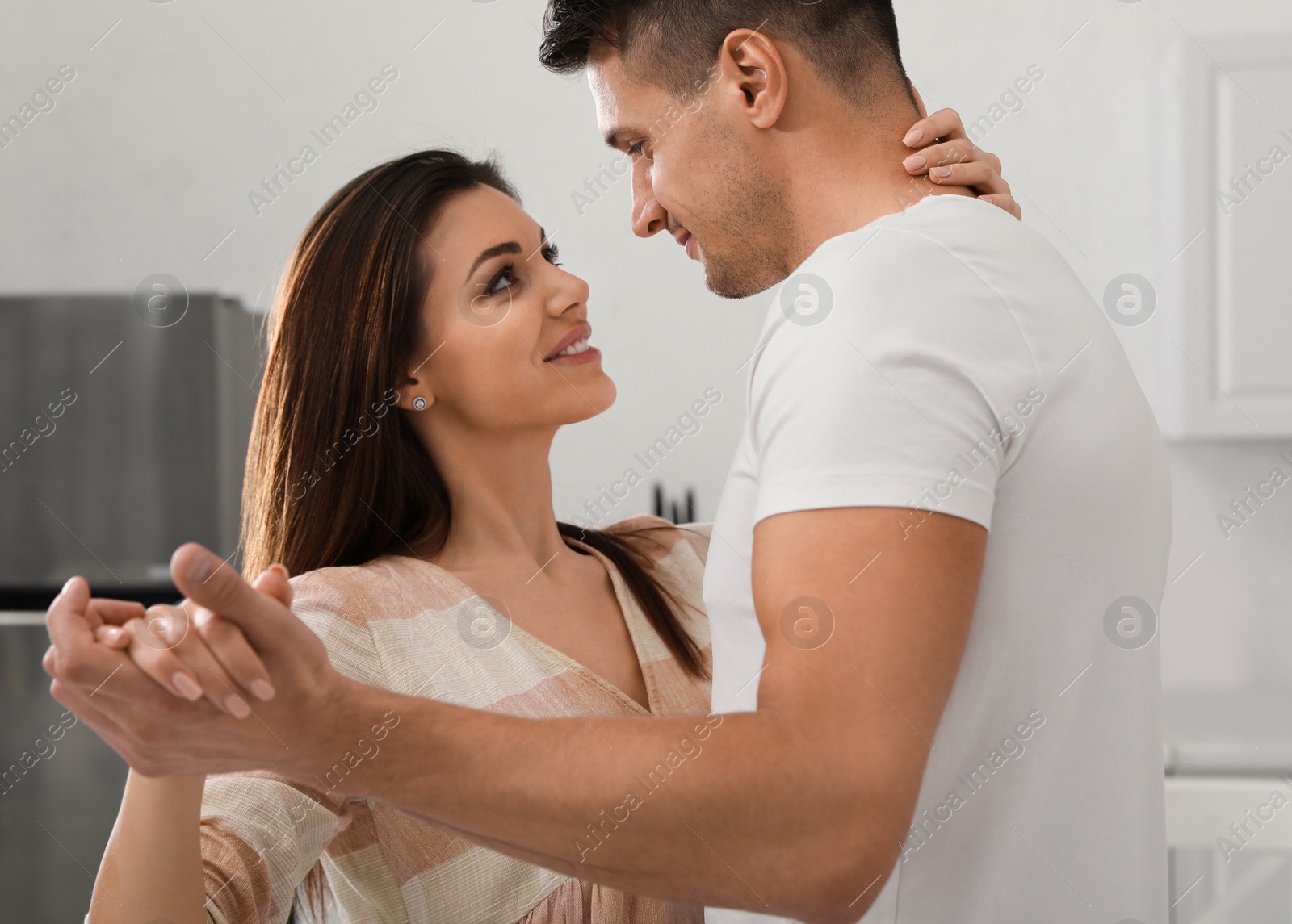 Photo of Happy young couple dancing together at home