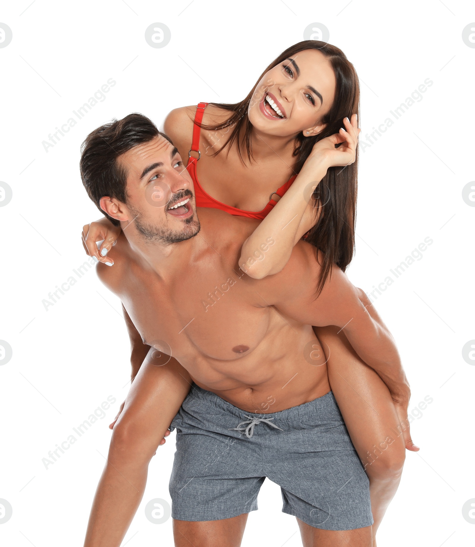 Photo of Young attractive couple in beachwear on white background