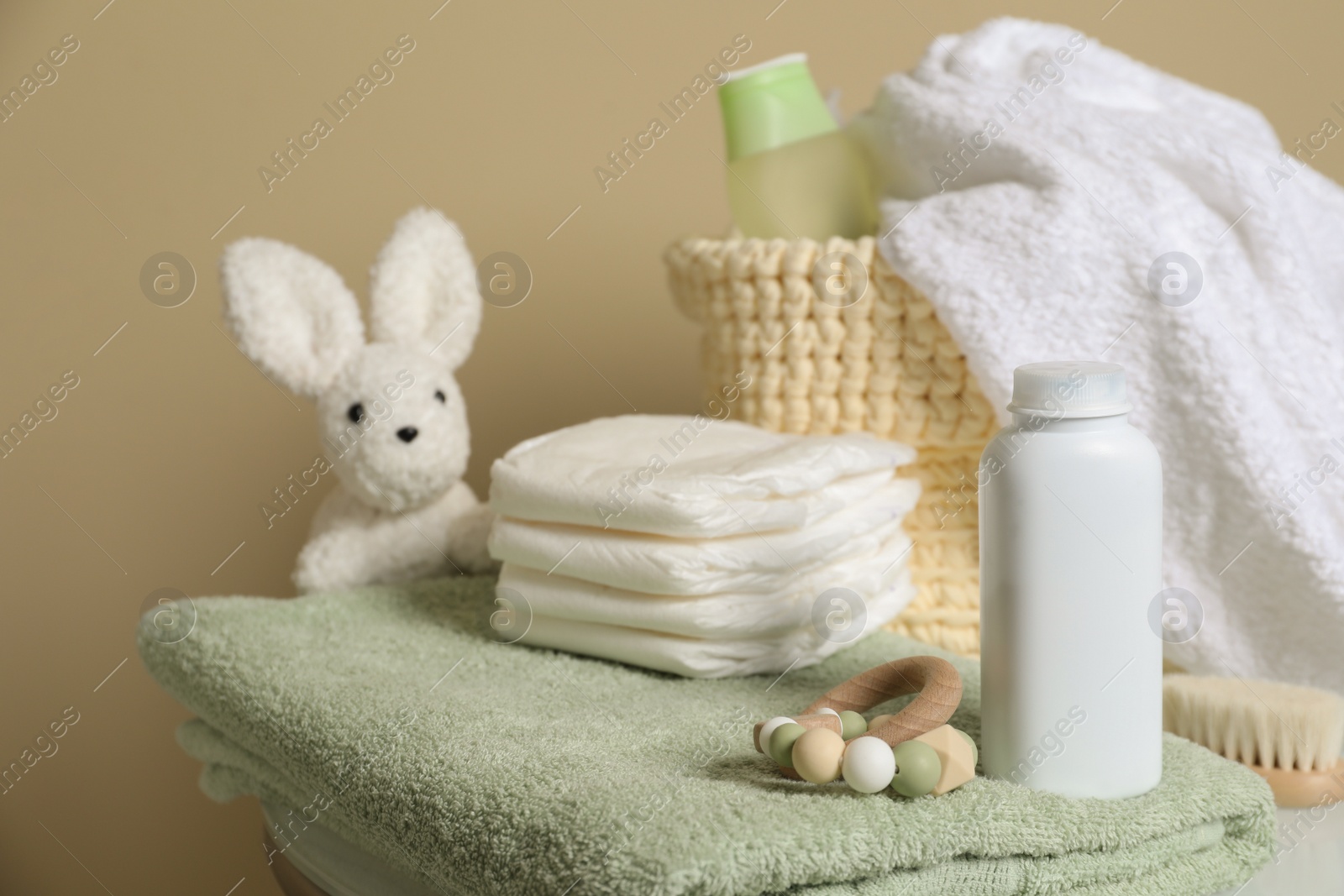 Photo of Baby cosmetic products, toys and accessories on beige background. Space for text