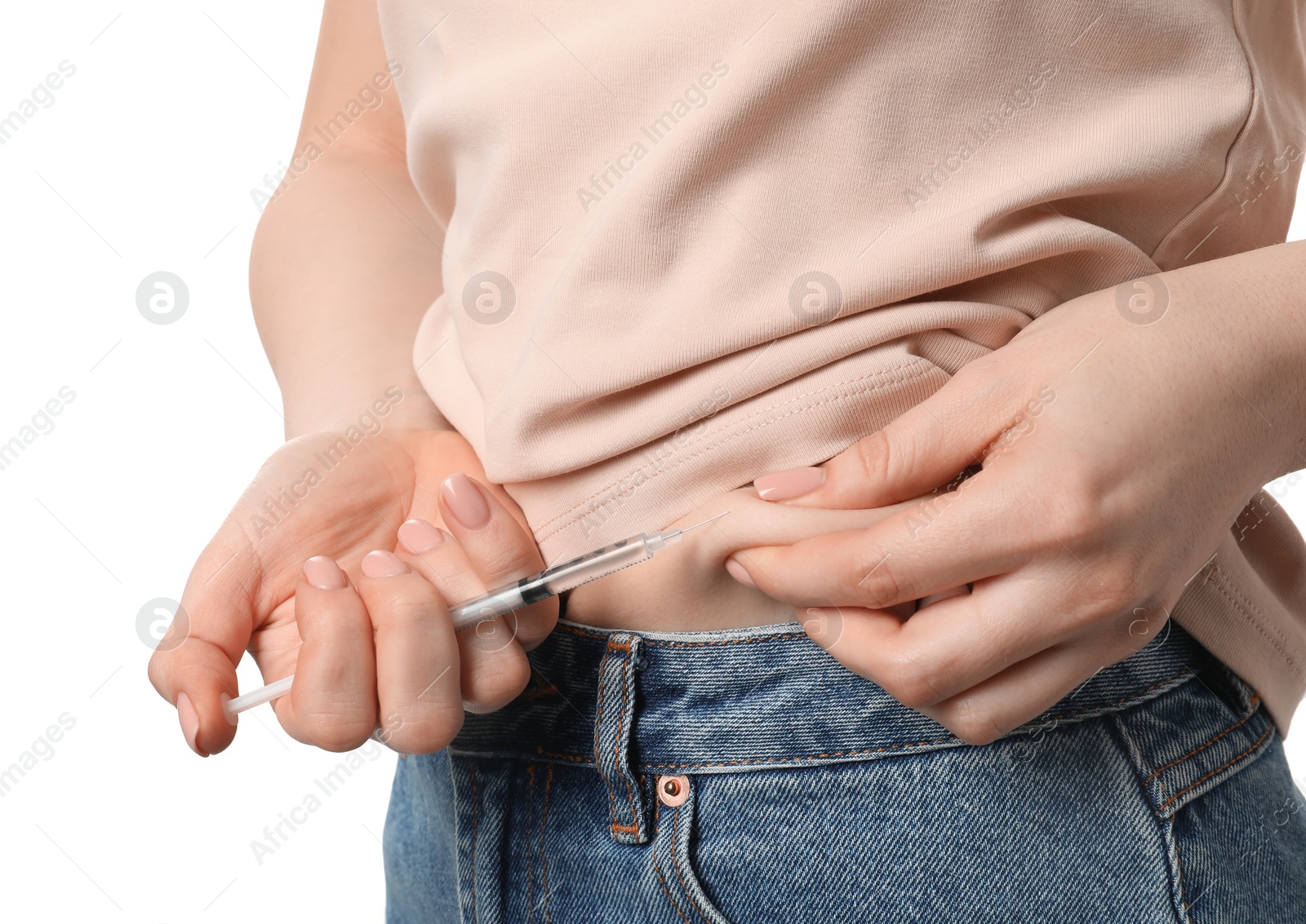 Photo of Diabetes. Woman making insulin injection into her belly on white background, closeup