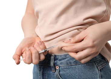 Diabetes. Woman making insulin injection into her belly on white background, closeup