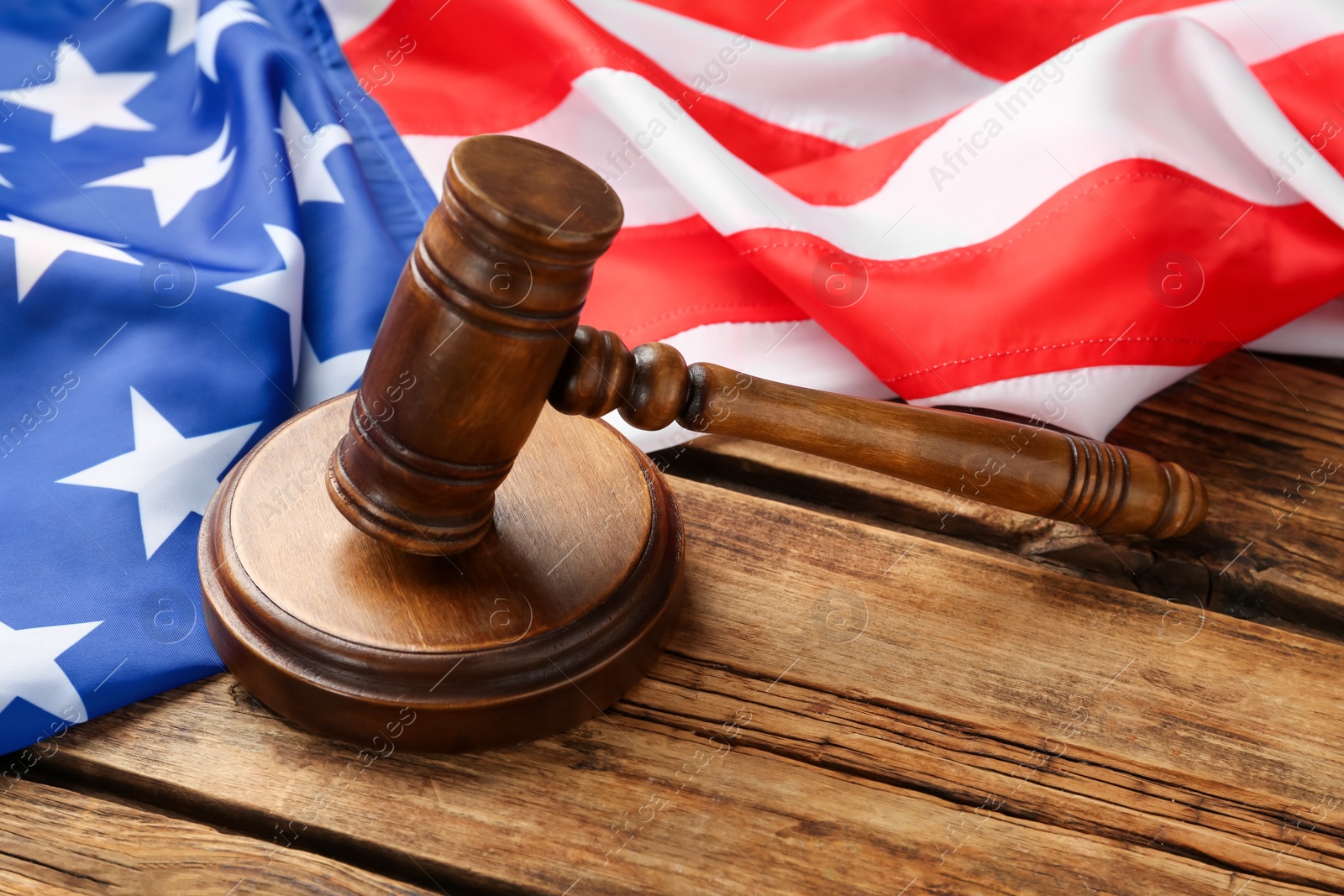 Photo of Wooden gavel and American flag on table