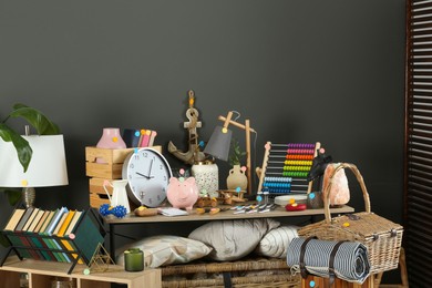 Photo of Many different items near grey wall. Garage sale