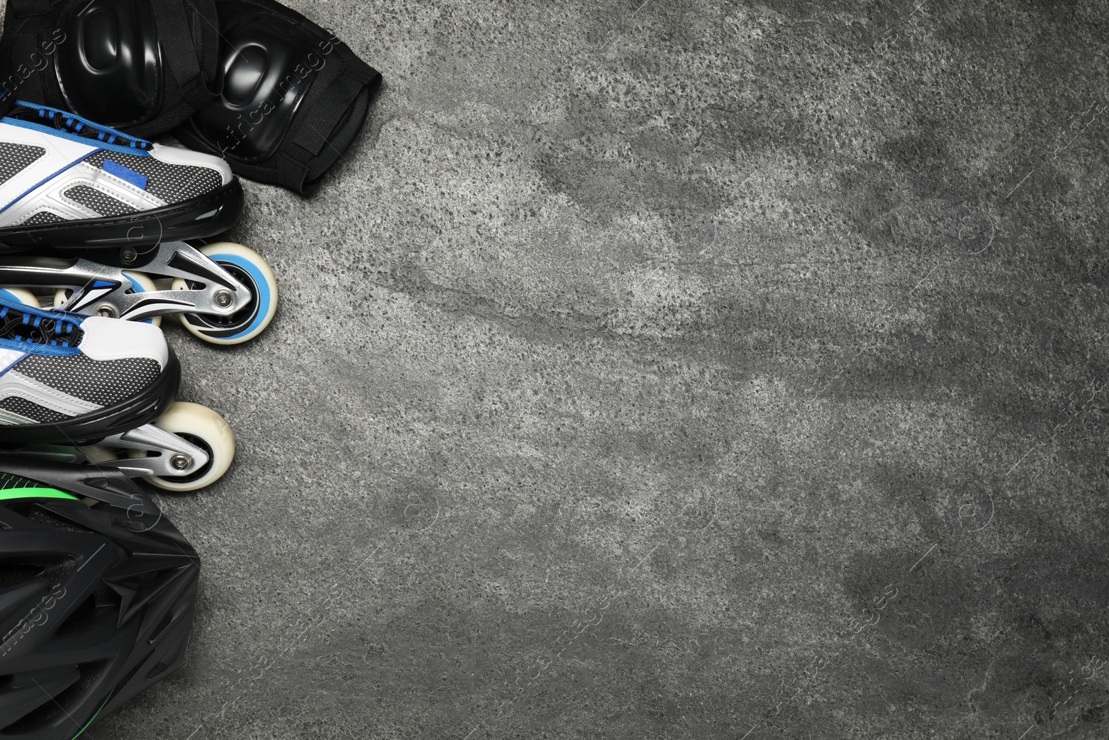 Photo of Different sports equipment on grey textured table, flat lay. Space for text