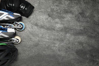 Photo of Different sports equipment on grey textured table, flat lay. Space for text