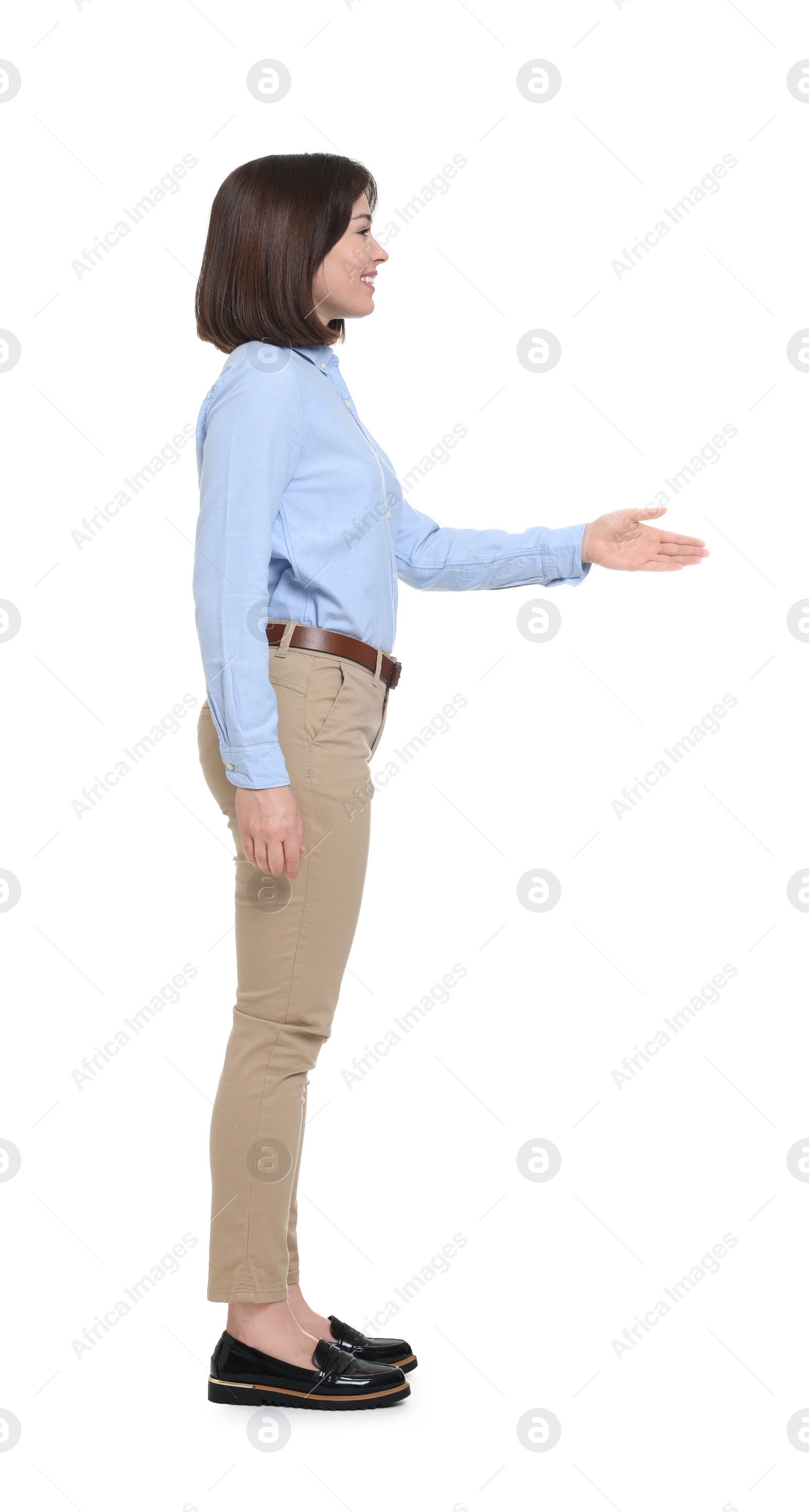 Photo of Happy businesswoman in blue shirt and beige pants on white background