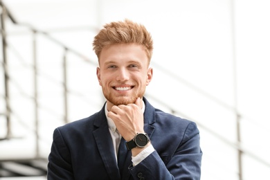 Photo of Portrait of handsome young man in elegant suit indoors