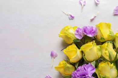 Photo of Flat lay composition with beautiful blooming flowers on light background