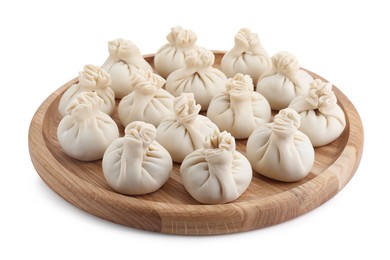 Wooden board with uncooked khinkali (dumplings) isolated on white. Georgian cuisine