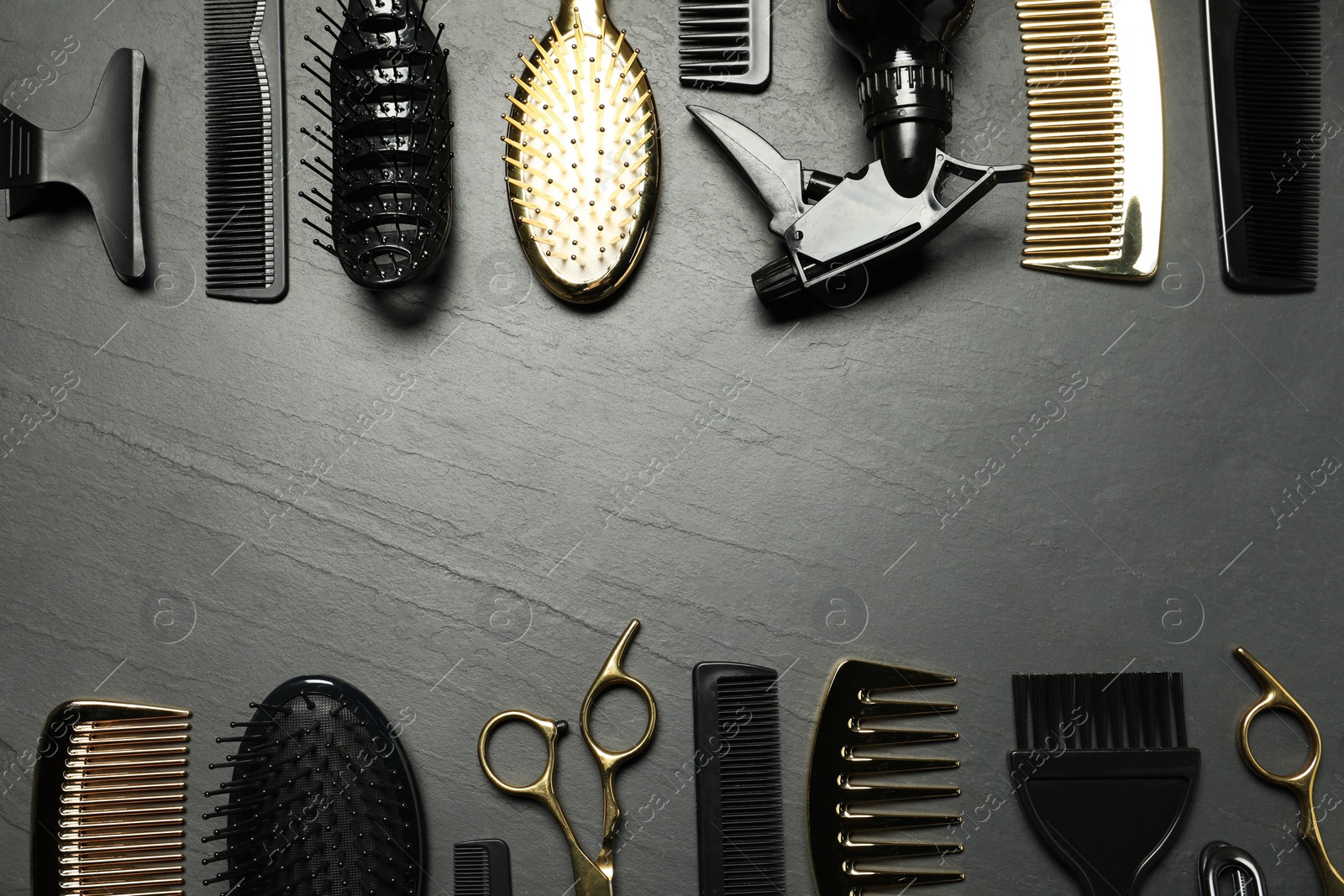 Photo of Hairdressing tools on grey textured background, flat lay. Space for text