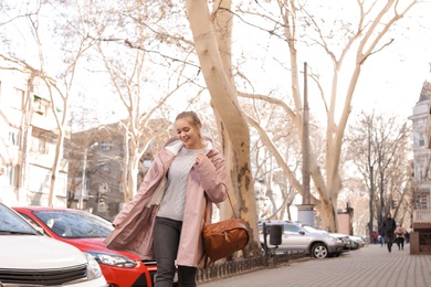 Photo of Portrait of happy young woman on city street