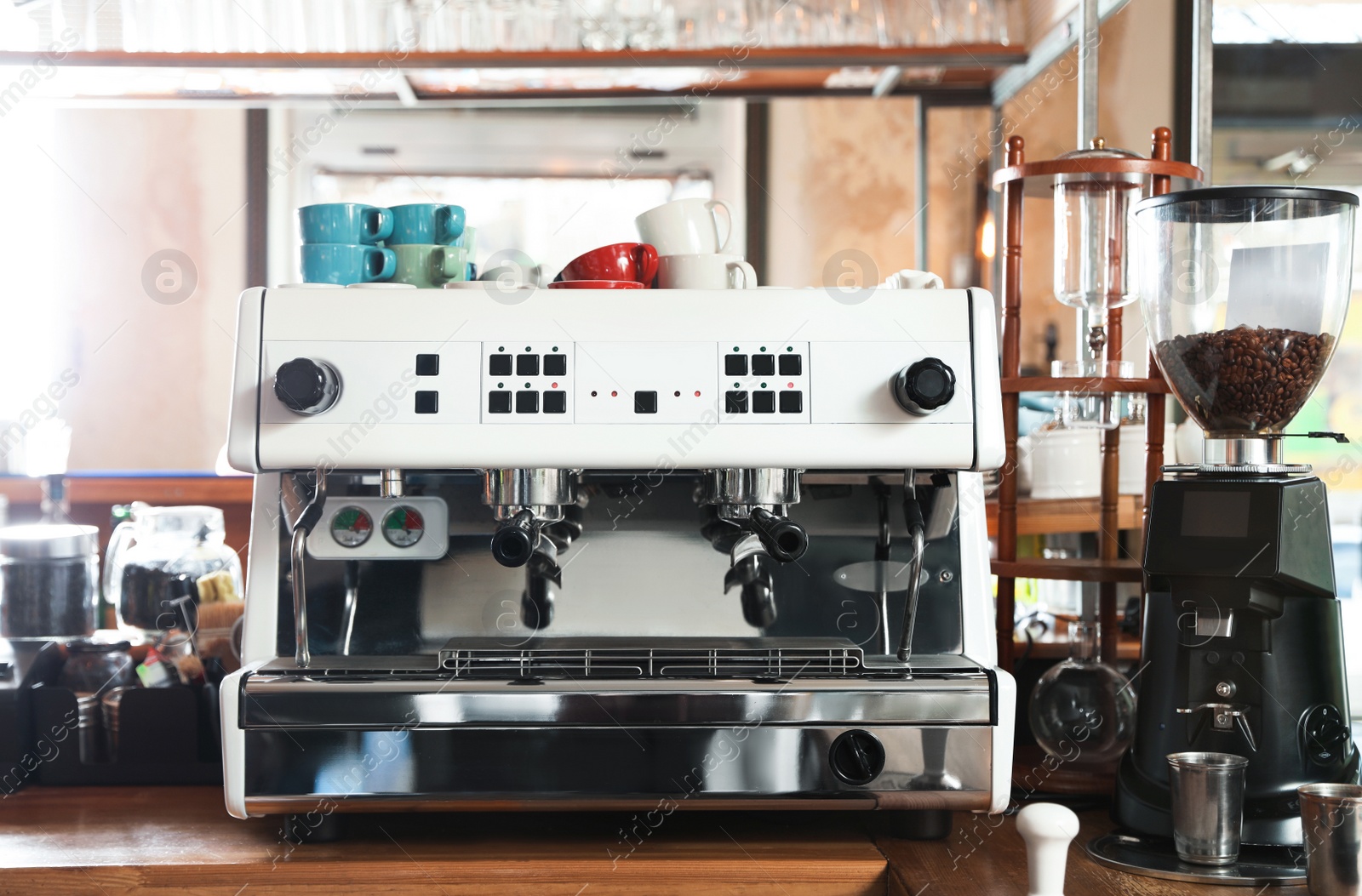 Photo of Modern coffee machine on bar counter in cafe