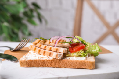 Photo of Delicious sandwich with chicken served on table