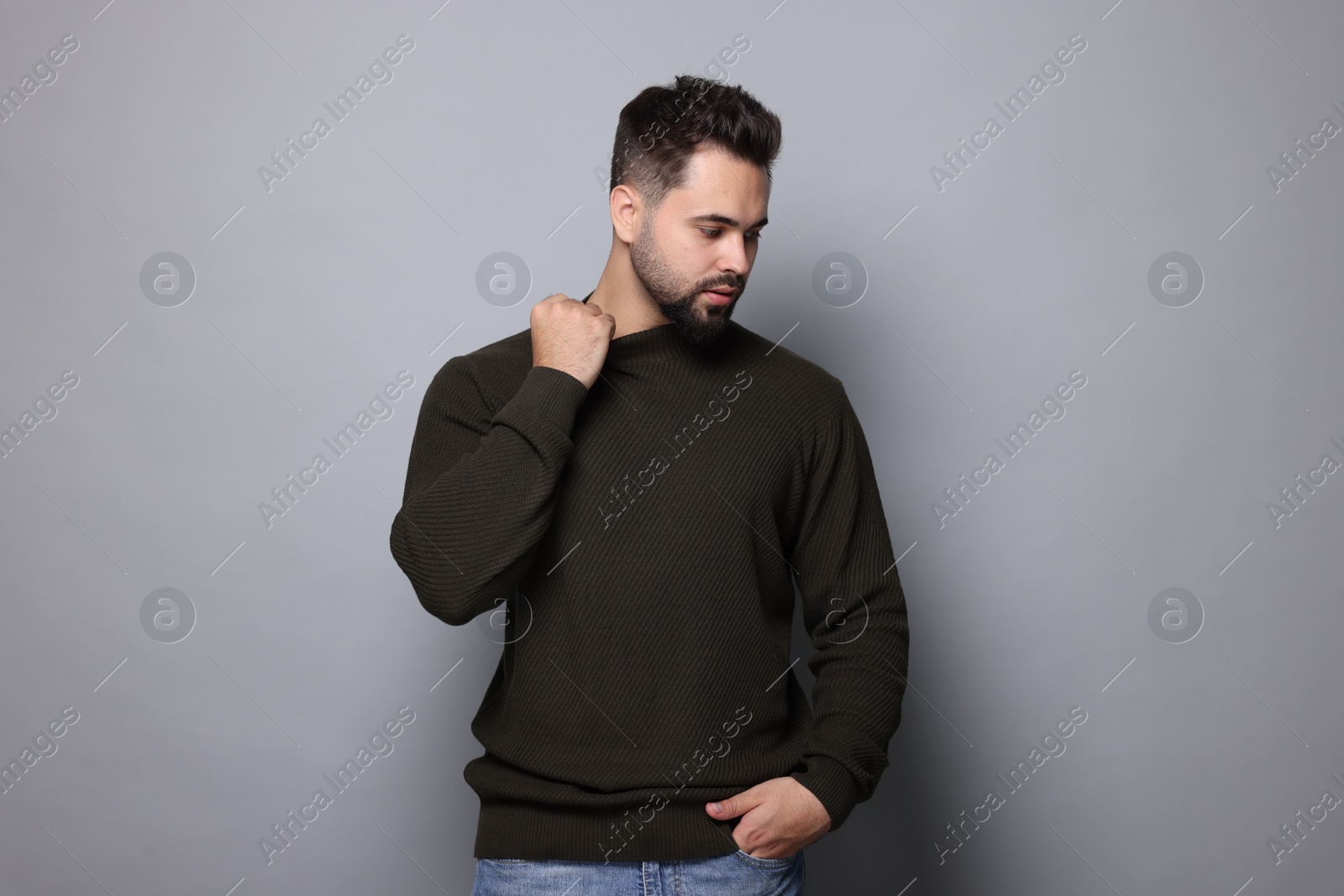 Photo of Handsome man in stylish sweater on grey background