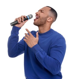 Handsome man with microphone singing on white background