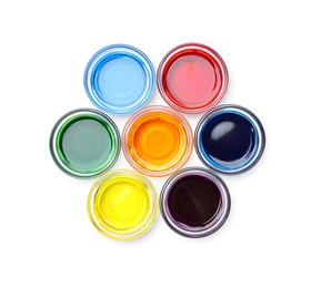 Photo of Glass bowls with different food coloring on white background, top view