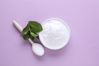 Photo of Sweet powdered fructose and mint leaves on light purple background, flat lay
