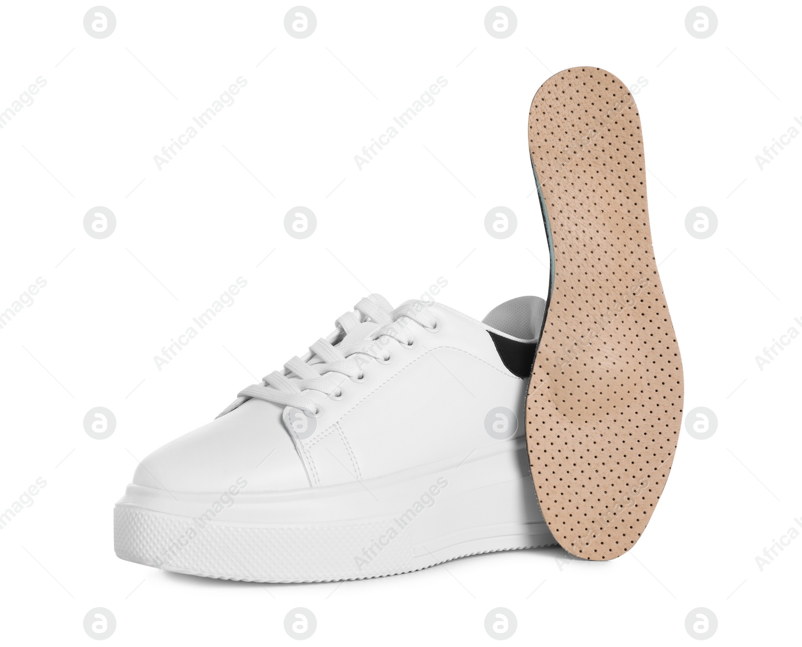 Photo of Orthopedic insole near shoe on white background