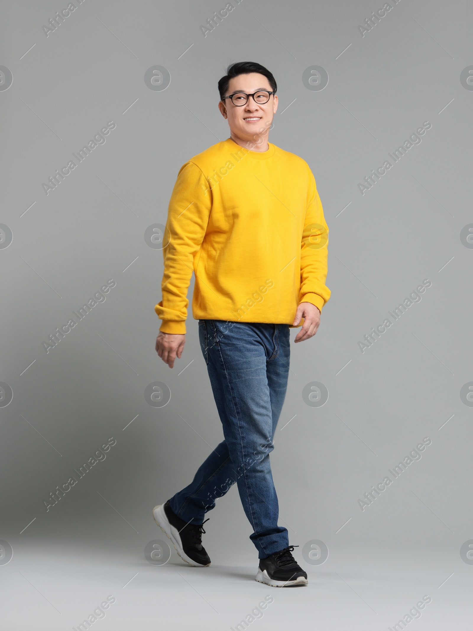 Photo of Full length portrait of happy man on grey background