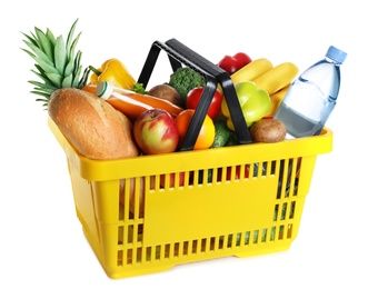 Shopping basket with grocery products on white background