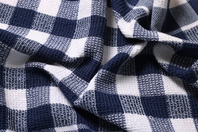 Photo of Texture of crumpled checkered fabric as background, top view