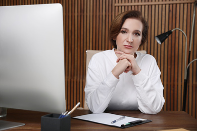 Portrait of psychotherapist at table in office